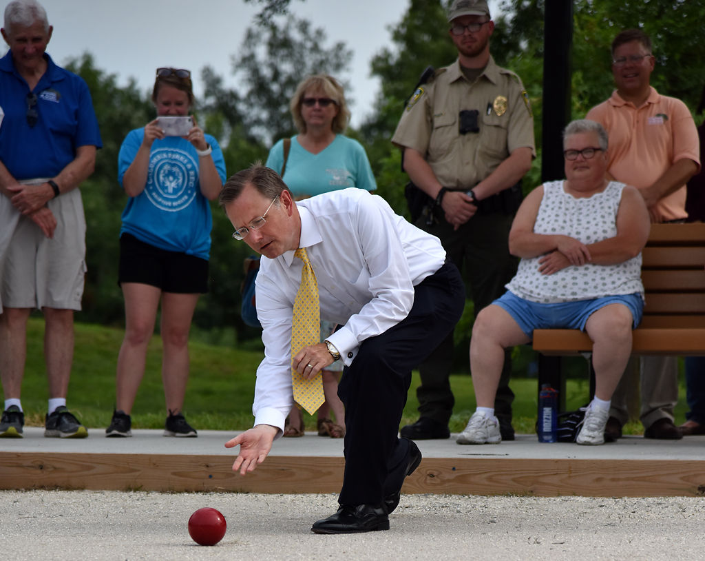 Brian Treece throws out the first ball on the new bocce ball courts